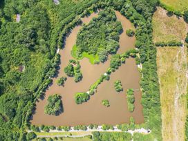 An aerial view of a lake surrounded by greenery at Rod and Rest in Dolton