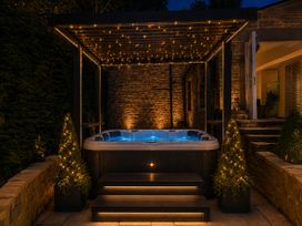 A hot tub with steps and surrounding lighting at Chowdene Lodge Estate