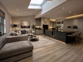 A living room with a sofa and kitchen island at Chowdene Lodge Estate