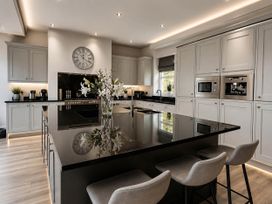 A kitchen with an island and appliances at Chowdene Lodge Estate 