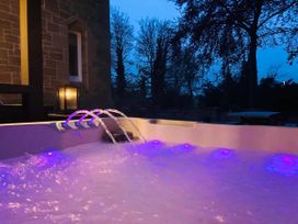 A hot tub with water jets and lights at Chowdene Lodge Estate