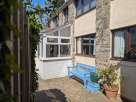 An outdoor area with a blue bench and planters at The Old Barn near St Ives Rustic Charm Space in Lelant