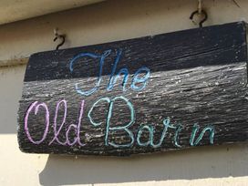 A wooden sign displaying the name The Old Barn near St Ives Rustic Charm Space Lelant