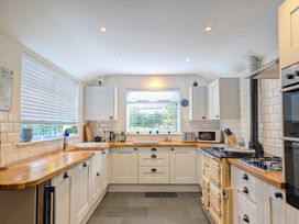 A kitchen with cabinets and stove at The Old Barn near St Ives Rustic Charm Space, Lelant