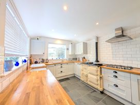A kitchen with stove and countertop at The Old Barn near St Ives Rustic Charm Space Lelant