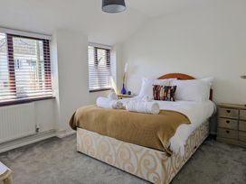 A bedroom with a bed and windows at The Old Barn near St Ives Rustic Charm Space Lelant