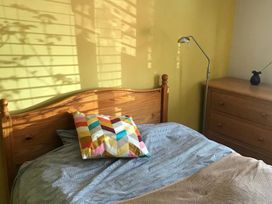 A bedroom with a bed and lamp at The Old Barn near St Ives Rustic Charm Space Lelant