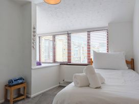 A bedroom with a bed and window at The Old Barn near St Ives Rustic Charm Space Lelant