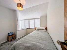 A bedroom with a bed and window at The Old Barn near St Ives Rustic Charm Space Lelant