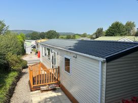 A mobile home with a deck and pathway at a residential area