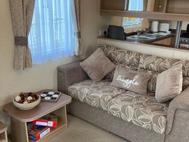 A living room with a sofa and coffee table at a property