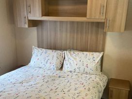 A bed with pillows and a nightstand at the property in 