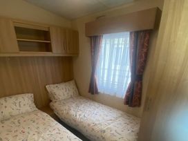 A bedroom with two beds and a window at the property
