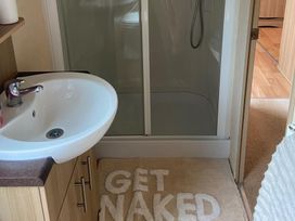 A bathroom with a sink and shower at the property