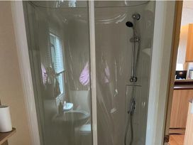 A shower enclosure with a toilet and sink visible in the bathroom at the property