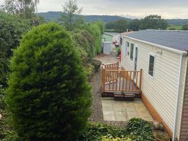 An outdoor area with a deck and mobile home at a campsite in an unknown location