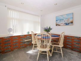 A dining room with a table and chairs at Seaside Bungalow in Rhyl
