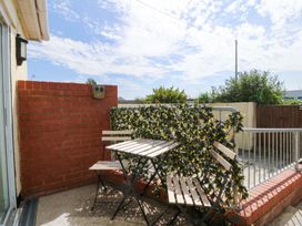 An outdoor area with a table and chairs at Seaside Bungalow in Rhyl