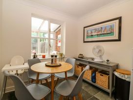 A dining room with a table and chairs at Robins Nest in Rhyl