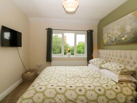 A bedroom with a bed and television at Robins Nest in Rhyl