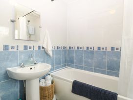 A bathroom with a tub and sink at Robins Nest in Rhyl