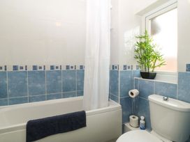 A bathroom with a bathtub and toilet at Robins Nest in Rhyl
