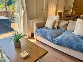A living room with a sofa and coffee table at Lakeside Retreat in Newton Abbot