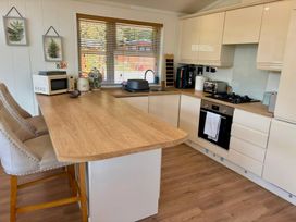 A kitchen with a sink and appliances at Lakeside Retreat in Newton Abbot