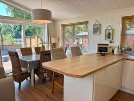 A kitchen with a table and chairs at Lakeside Retreat Newton Abbot