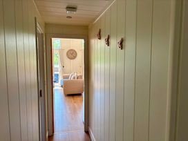A hallway with a view into a living room at Lakeside Retreat in Newton Abbot
