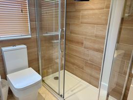 A bathroom with a shower and toilet at Lakeside Retreat in Newton Abbot