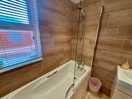 A bathroom with a bathtub and shower at Lakeside Retreat in Newton Abbot
