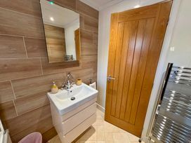 A bathroom with a sink and a mirror at Lakeside Retreat in Newton Abbot