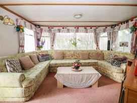 A living room with a sectional sofa and a coffee table at 10 Cater Gardens in Guildford