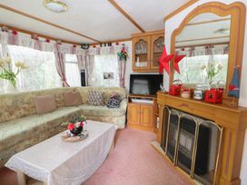 A living room with a sofa and a coffee table at 10 Cater Gardens in Guildford