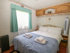 A bedroom with a bed and nightstand at 10 Cater Gardens Guildford
