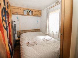 A bedroom with a bed and wall art at 10 Cater Gardens in Guildford