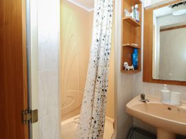 A bathroom with a shower and sink at 10 Cater Gardens in Guildford