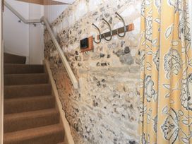 A staircase with a wall and coat hooks at Frome Gazey in Frampton