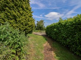 A pathway leading to a seating area in the garden at Owl in Pickering