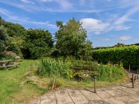 A garden with a pond and benches at Owl in Pickering