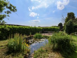 A garden with a pond and benches at Owl in Pickering