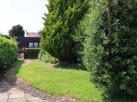 A garden with a pathway and trees at Owl in Pickering