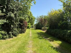 A garden pathway leading to furniture at Owl in Pickering