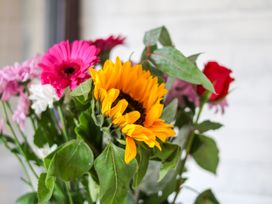 A bouquet of flowers including sunflowers and gerberas at Owl in Pickering