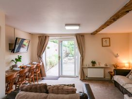 A living room with a dining area and access to the garden at Owl in Pickering