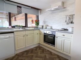 A kitchen with appliances and a sink at Owl in Pickering