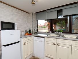 A kitchen with a refrigerator and sink at Owl in Pickering