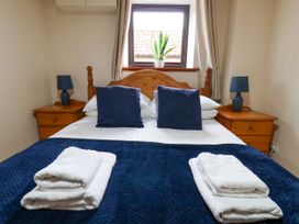 A bedroom with a bed and nightstands at Owl in Pickering