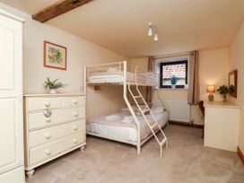 A bedroom with a bunk bed and chest of drawers at Owl in Pickering